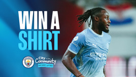 Image promoting a competition to win a Manchester City shirt. Features text 'WIN A SHIRT' alongside a Manchester City player in action. Includes logos and Manchester City in the Community branding.