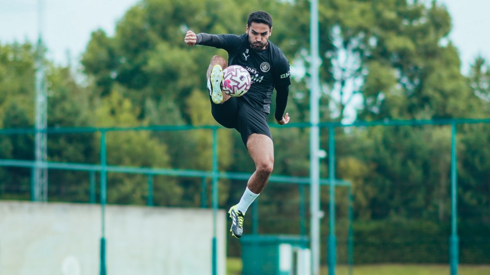 AIR TIME : Ilkay Gundogan jumps to control the ball