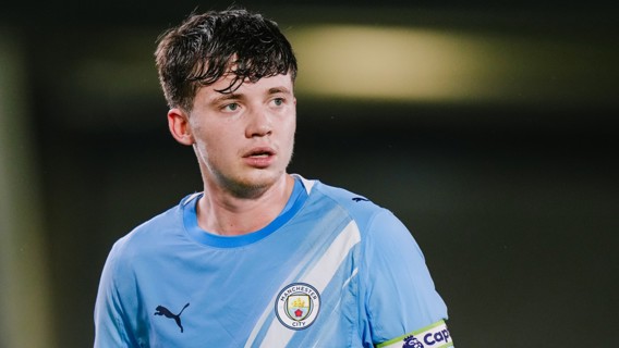 A Manchester City player wearing a blue Puma jersey with the club emblem.