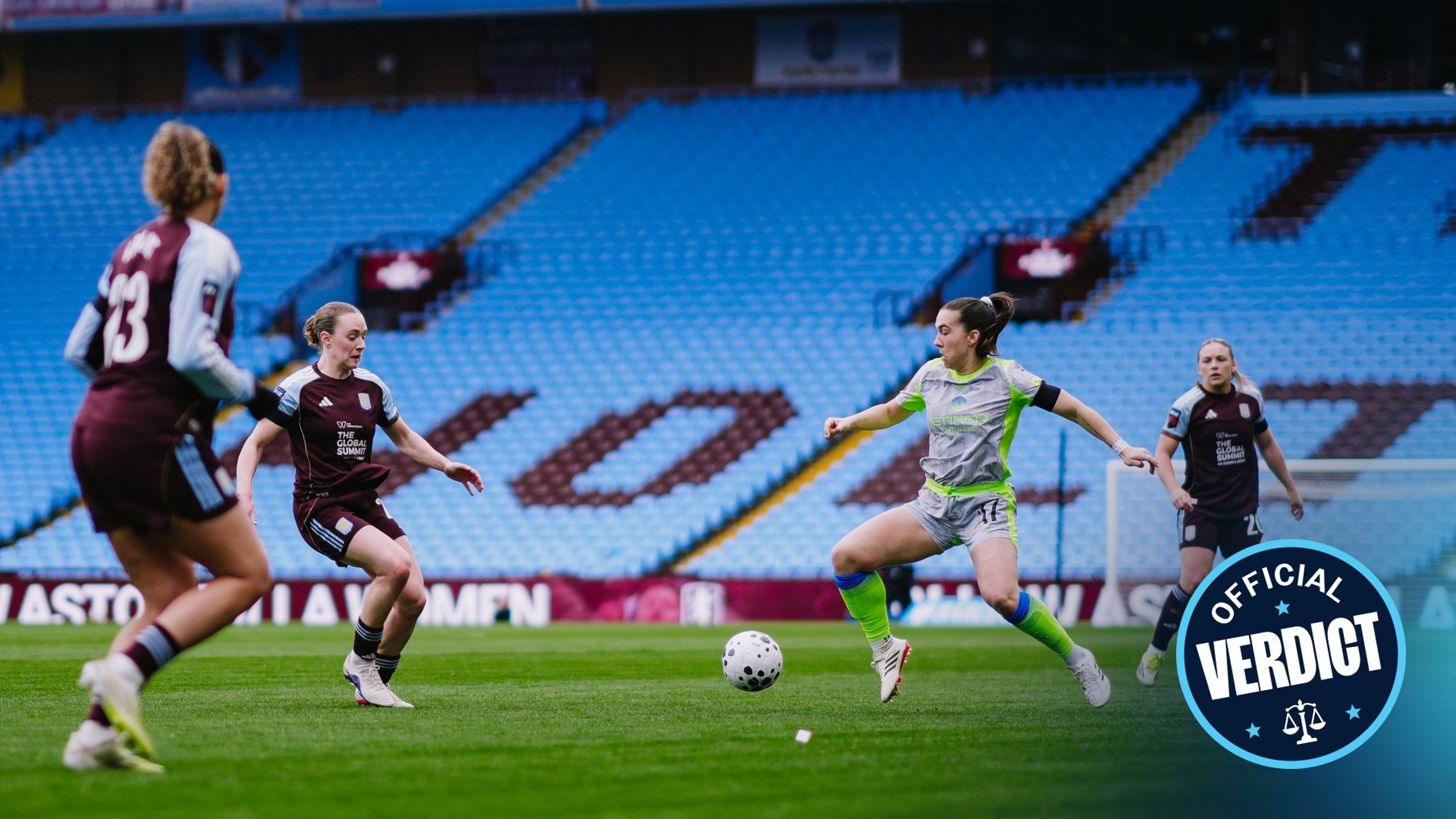 Players from two teams, Villa and City, actively engaged in a soccer match at a stadium with blue seats. The focus is on a player attempting to control the ball.