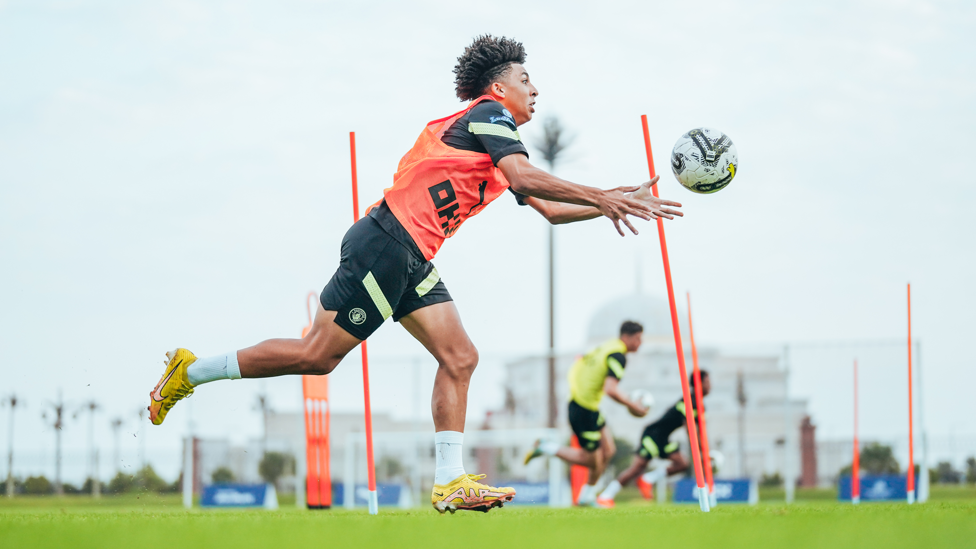 HOWZAT? : Rico Lewis swaps feet for hands as the players have fun in training.