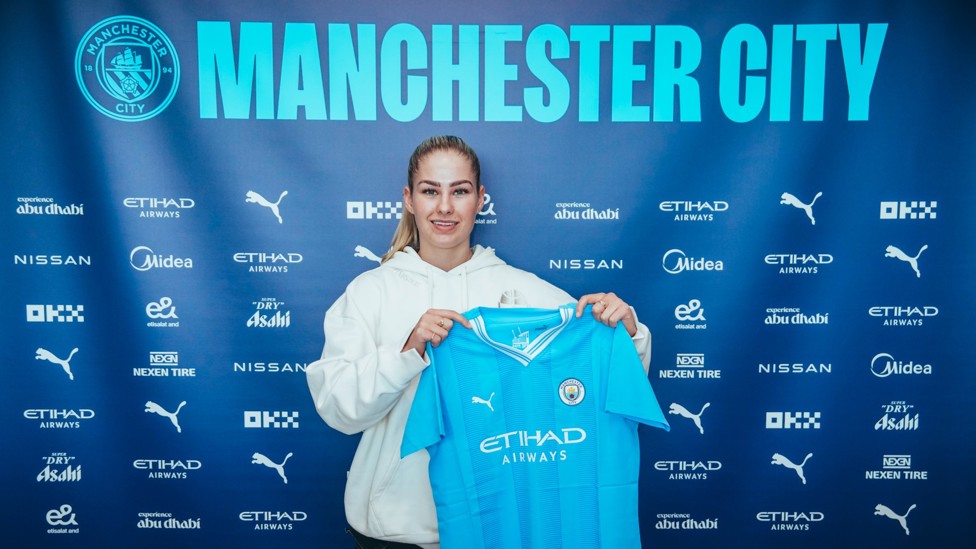 MY NEW SHIRT : Tara holds the City home shirt aloft