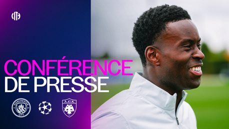 Graphic for Man City vs AEK Athens press conference with UEFA Champions League logos, featuring a smiling individual.