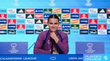 A person in a purple uniform sits at a press conference table with a UEFA Women’s Champions League logo. Behind are sponsor logos including Adidas, Heineken, PayPal, and Disney.