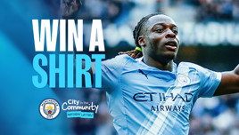 Promotional image for Manchester City's 'City in the Community' matchday lottery. Features a player celebrating in a Manchester City shirt encouraging participation with the text 'Win a Shirt'.