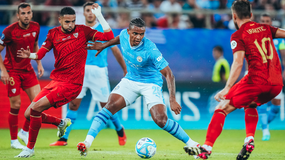 CENTRE OF ATTENTION: Manuel Akanji fends off the Sevilla front-line