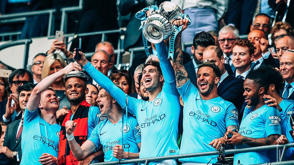WINNERS : Stones leads the celebrations at Wembley last month
