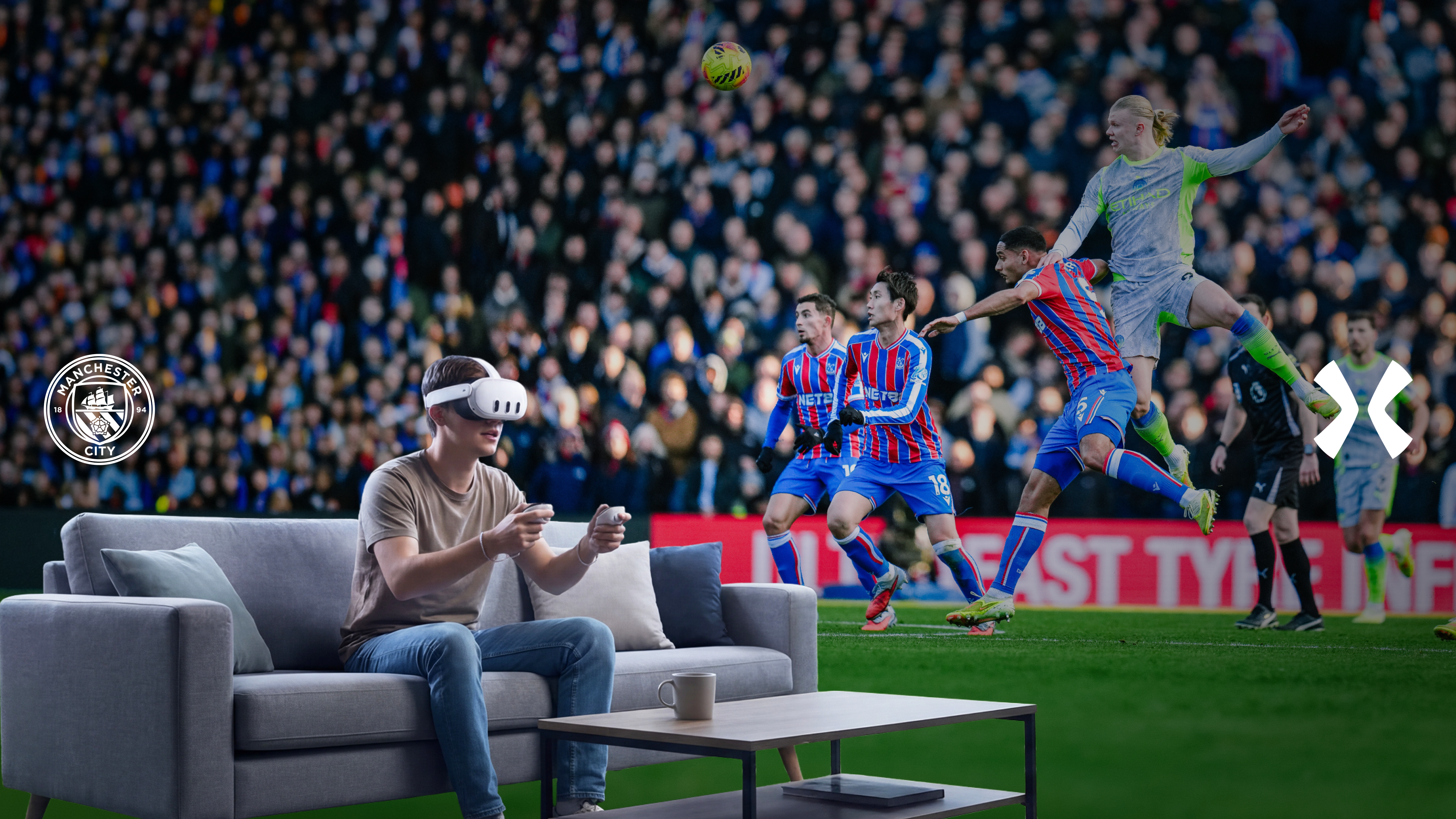 A person wearing a VR headset and holding controllers sits on a couch in front of a soccer match between Manchester City and Crystal Palace. The Manchester City logo is on the left.