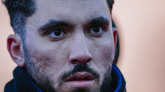 Image showing a side view of a person's ear and neck in focus, while face is blurred.