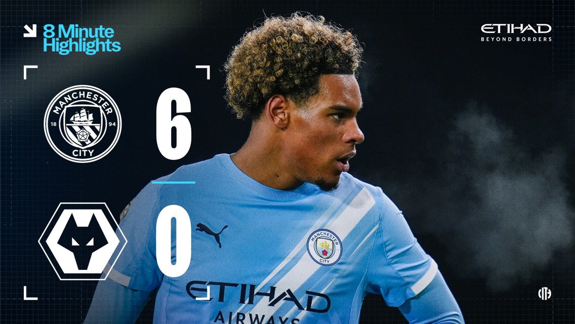 Scoreboard showing Manchester City 6-0 Wolves with a player in a Manchester City kit.