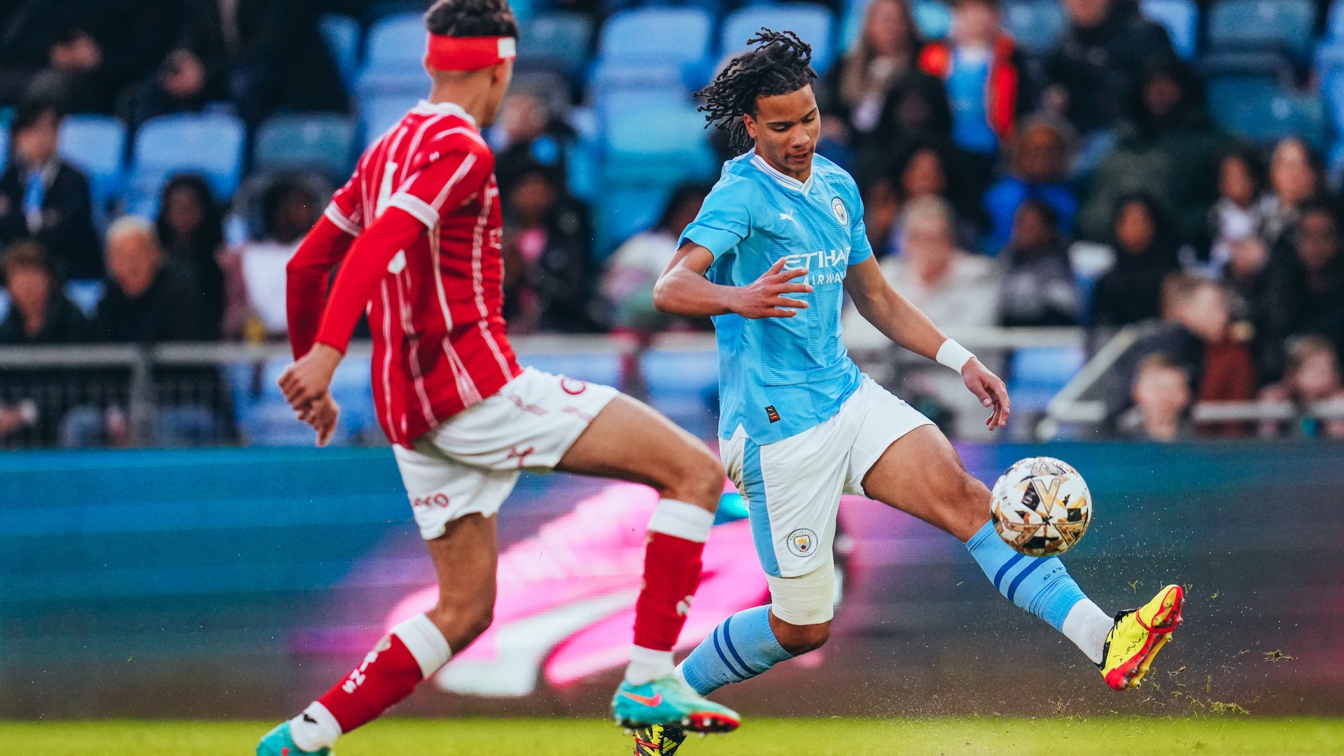 ACTION STATIONS: Divine Mukasa takes the fight to Bristol City.