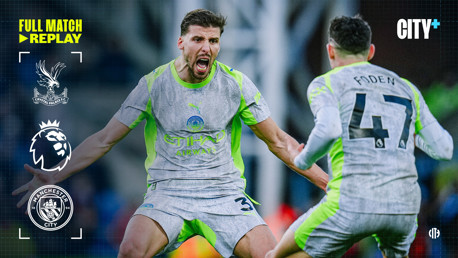 Two Manchester City players celebrate in a match against Crystal Palace, with team logos displayed and the words 'Full Match Replay' indicating a video replay availability on CITY+, an online streaming service.