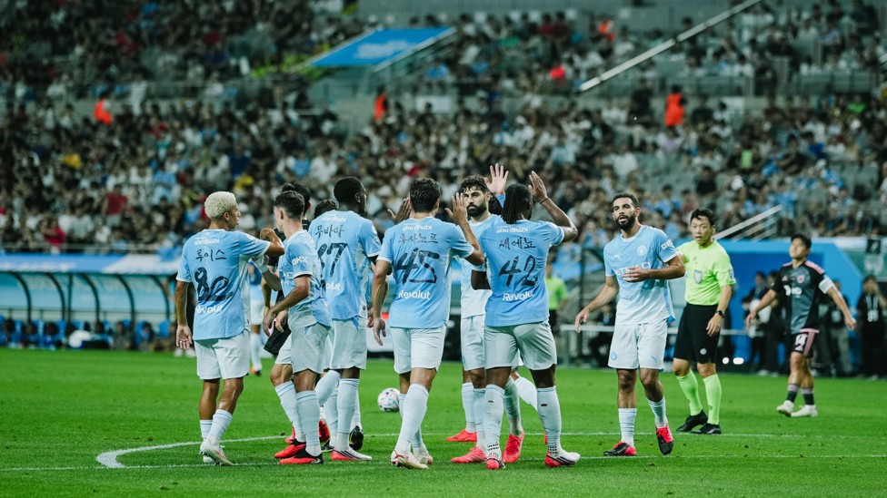 HIGH FIVES ALL ROUND: The players rejoice following Ait Nouri's opening goal