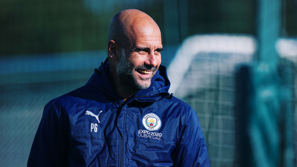 BOSSING IT : Pep Guardiola shows off his pearly whites