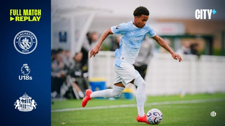A Manchester City U18 player in light blue kit controlling the ball during a match. Text mentions a full match replay between Manchester City U18s and Sunderland.