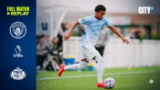 A Manchester City U18 player in light blue kit controlling the ball during a match. Text mentions a full match replay between Manchester City U18s and Sunderland.