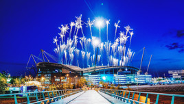 Bright fireworks illuminate the sky over Etihad Stadium during the night.