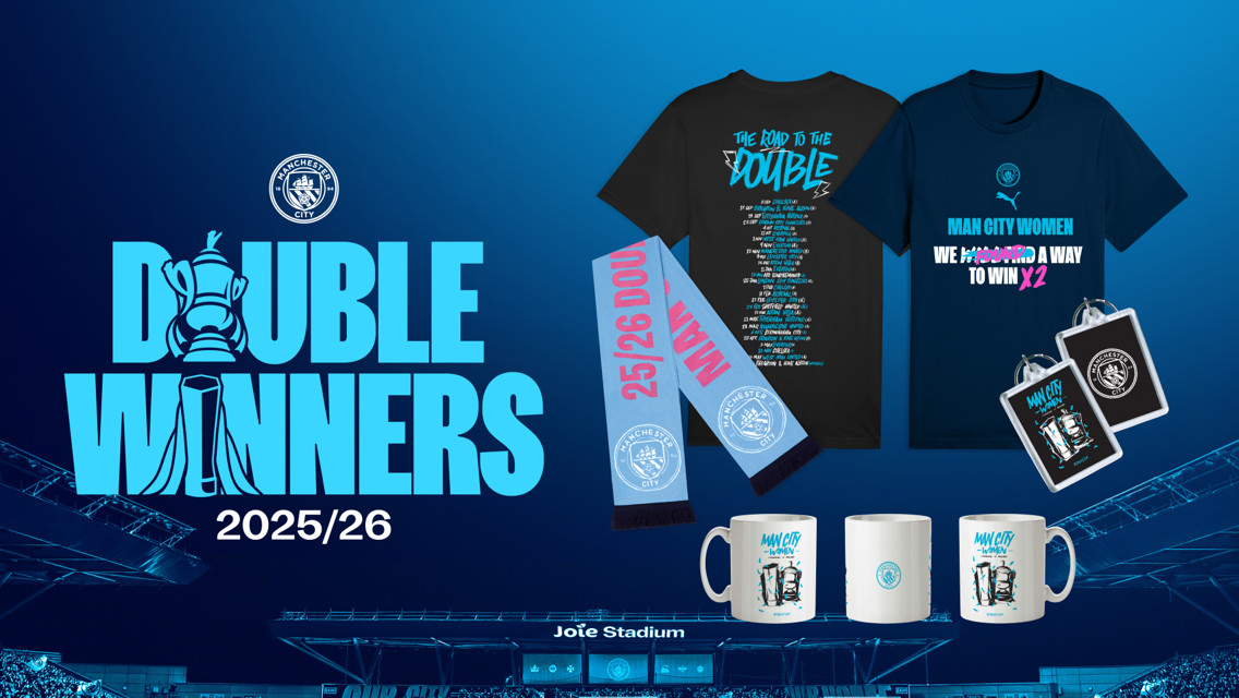 Manchester City celebrates their 2025/26 double win with merchandise including t-shirts, mugs, and scarves.