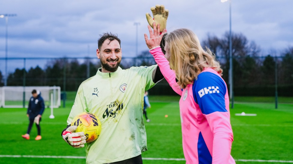 HIGH FIVE : Gianluigi Donnarumma and Erling Haaland share a moment