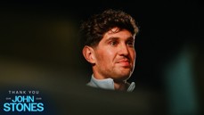 An image featuring text 'Thank You John Stones 2016-2026' with a blurred face. The text is in electric blue against a dark background.