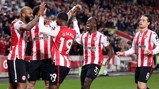 A group of Brentford FC players wearing their red and white striped jerseys celebrate on the field during a match.