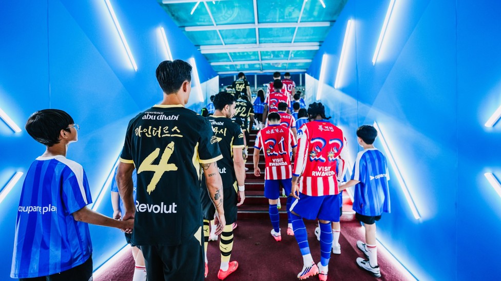 WALK OUT: Both teams head out for kick-off