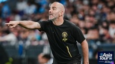 A person coaching wearing a black Manchester City shirt with an 'Asia Tour '26' logo on the side.