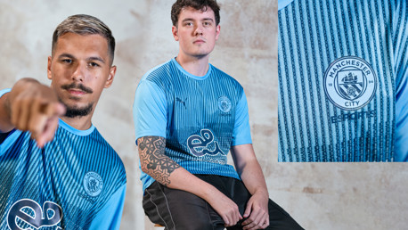 Esports players wearing a blue Manchester City jersey with esports logo.