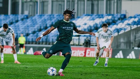 New York City player in Manchester City kit taking a penalty against Real Madrid during a football match.