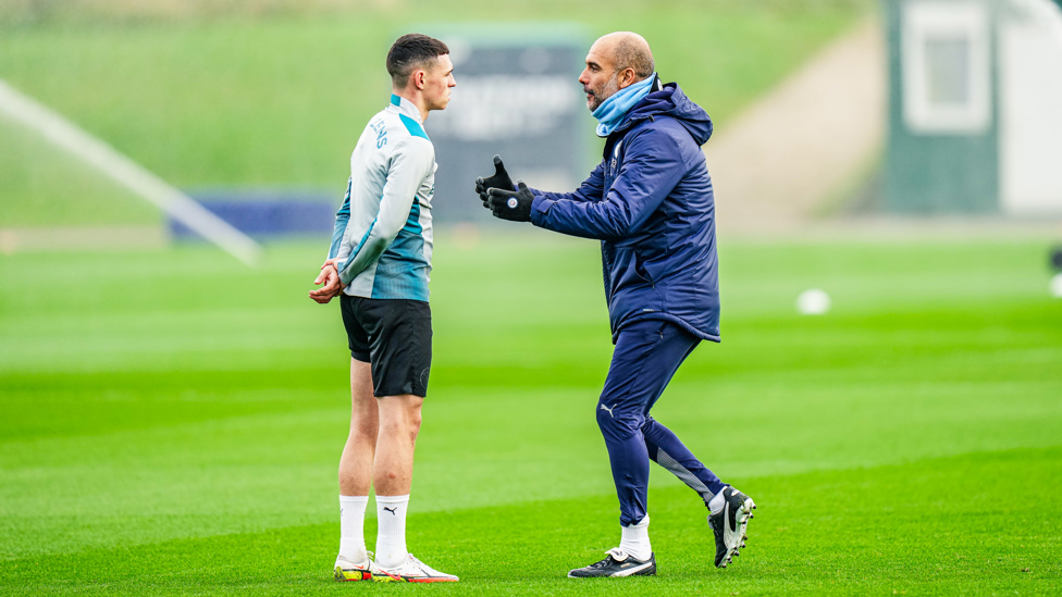 PEP TALK: The boss passes on some pointers to Phil Foden